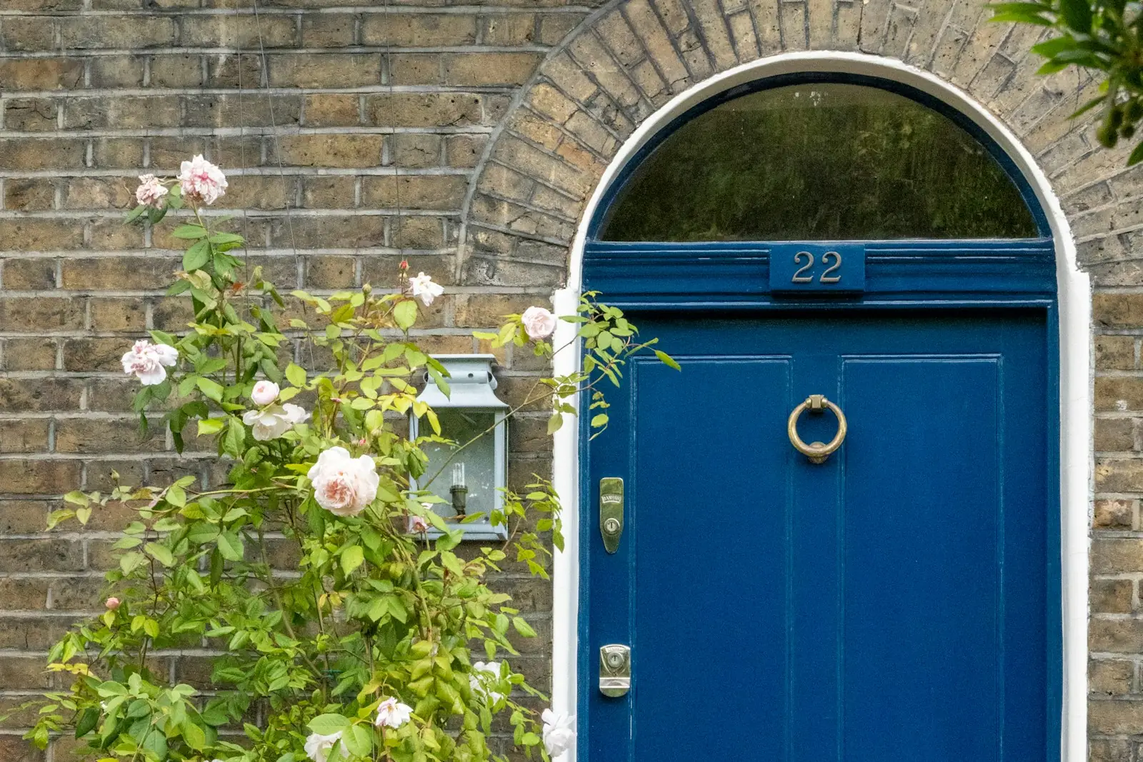 Painted blue front door in a brick terraced house