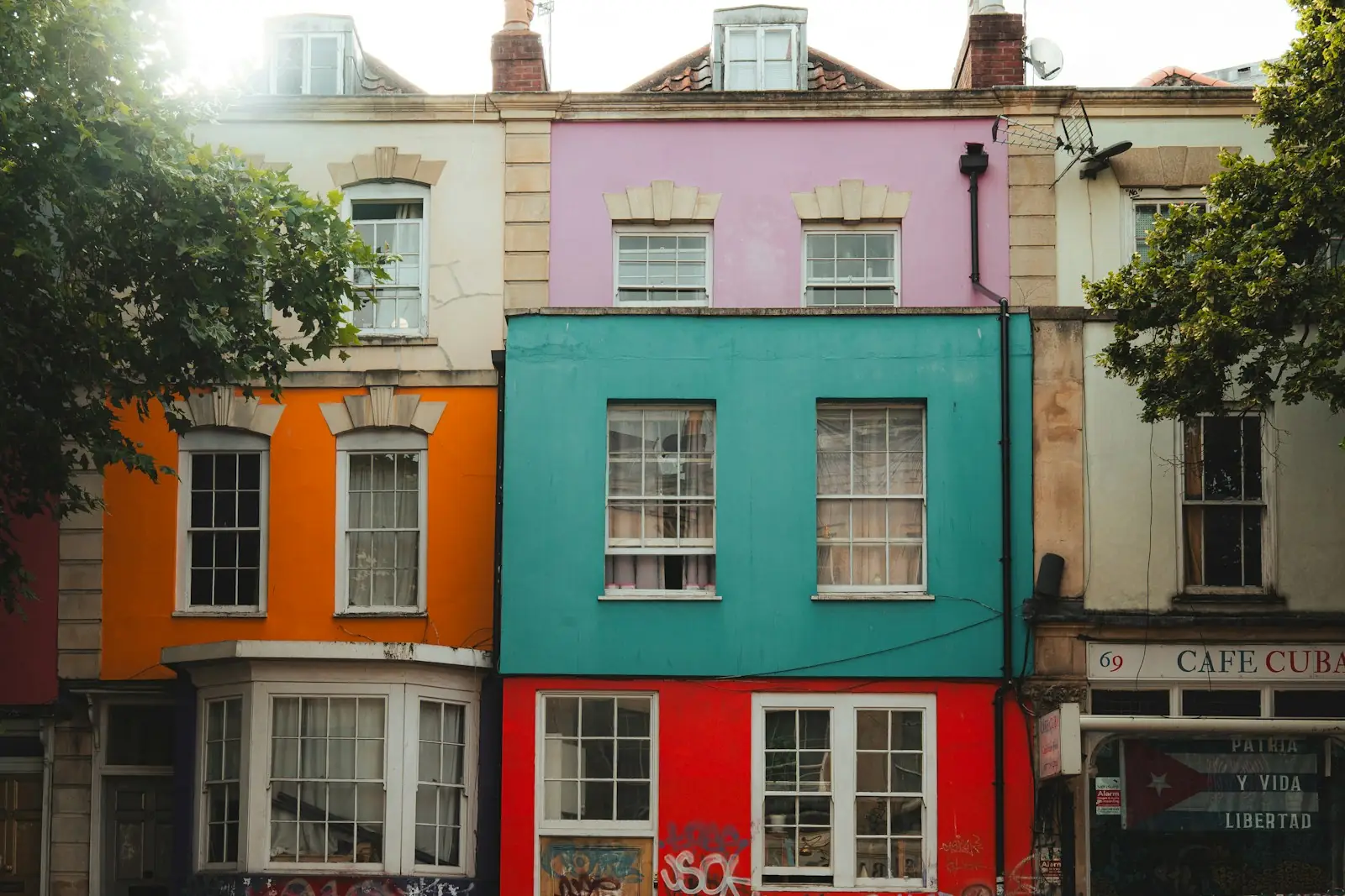 Brightly painted shops and flats with bay windows