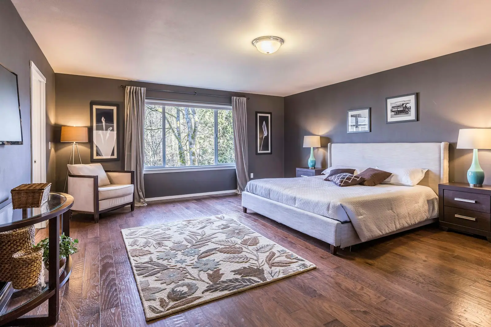 Large bedroom decorated in warm grey with white woodwork