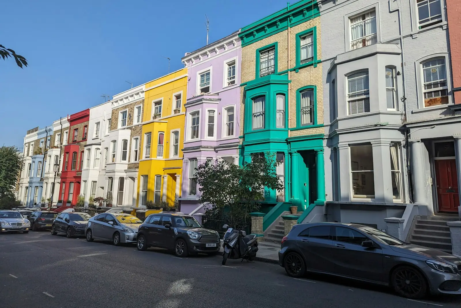 Row of colourfully painted Victorian terraced houses in London