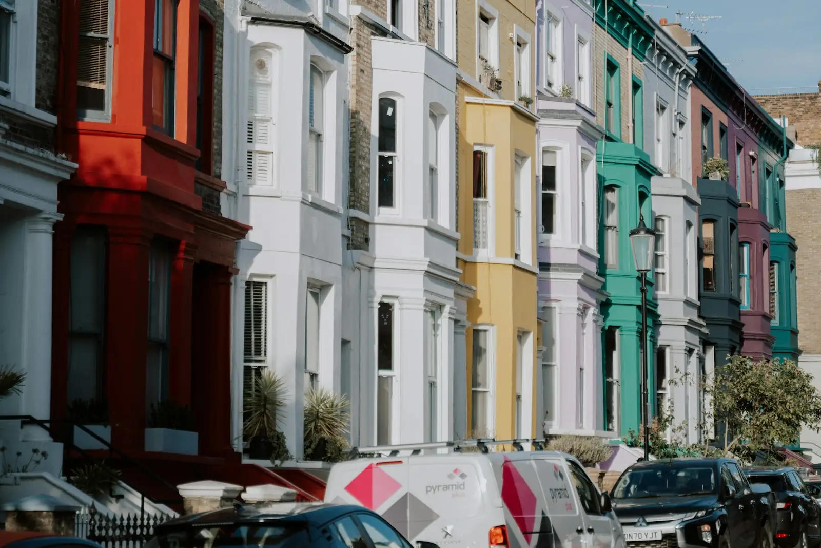 Street of pastel and brightly painted terraced houses in London
